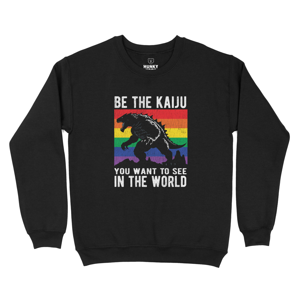 "Be the Kaiju You Want to See in the World" kaiju over a rainbow flag on a black crewneck sweatshirt, flat lay #color_Black
