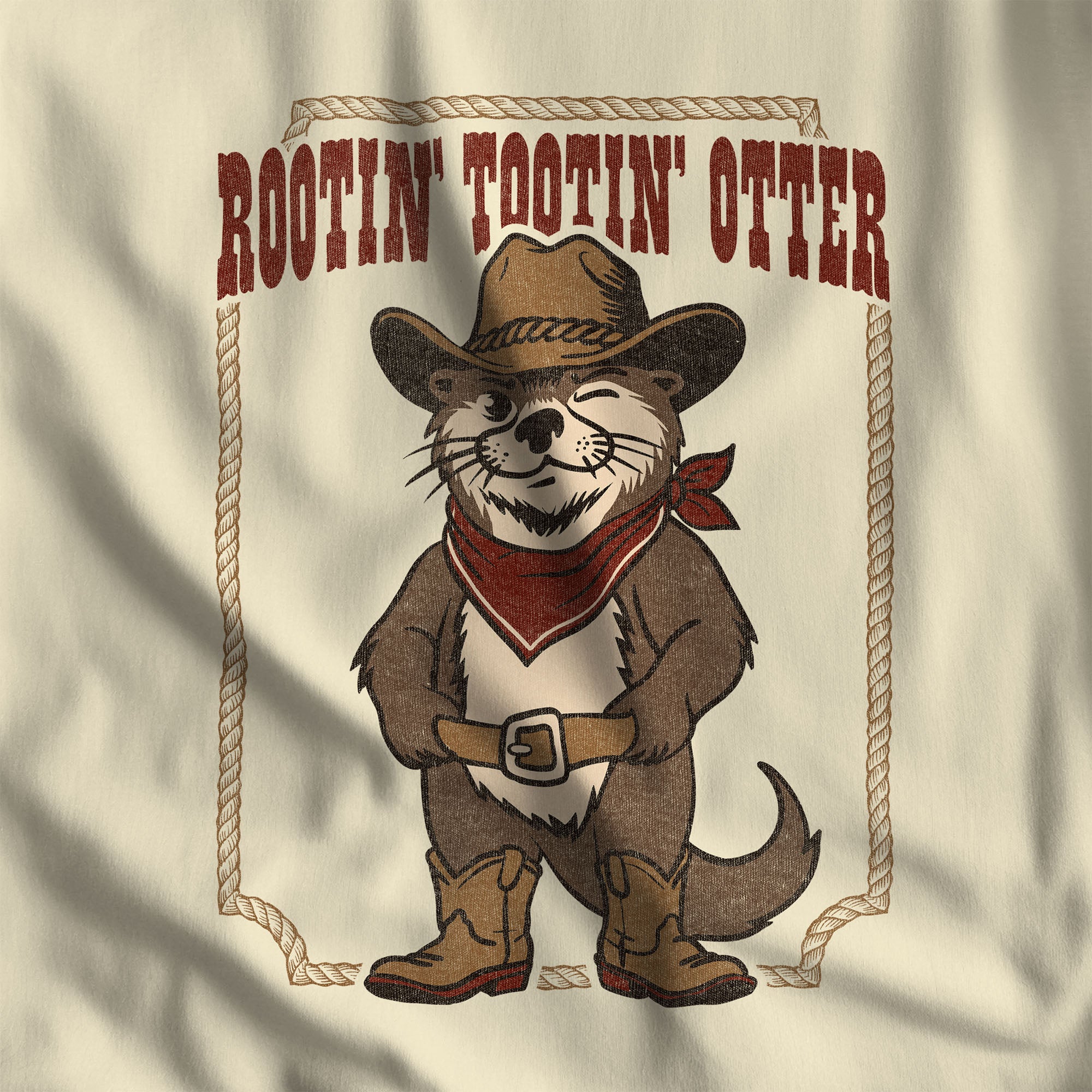 Close-up of the Rootin' Tootin' Otter western print on natural and maroon ringer t-shirt fabric #color_Natural/Maroon